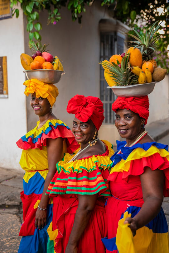 Women in Colorful Dress Selling Fruits on the Street 